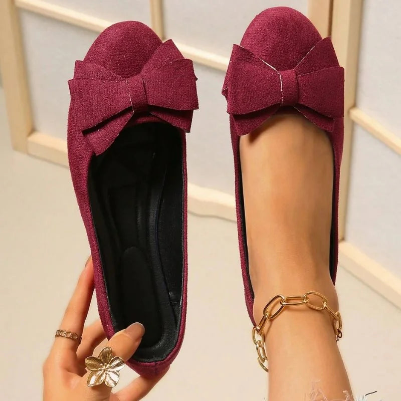 Red ballet flat shown on foot with the cushioned footbed visible