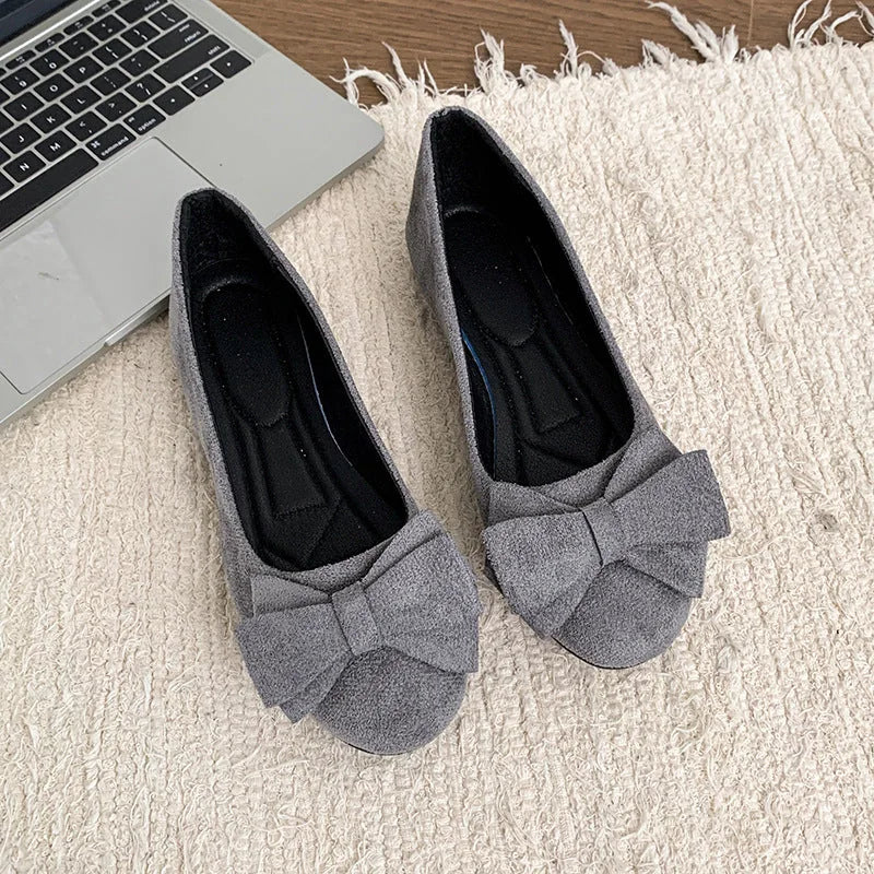 Pair of grey bow ballet flats, top view