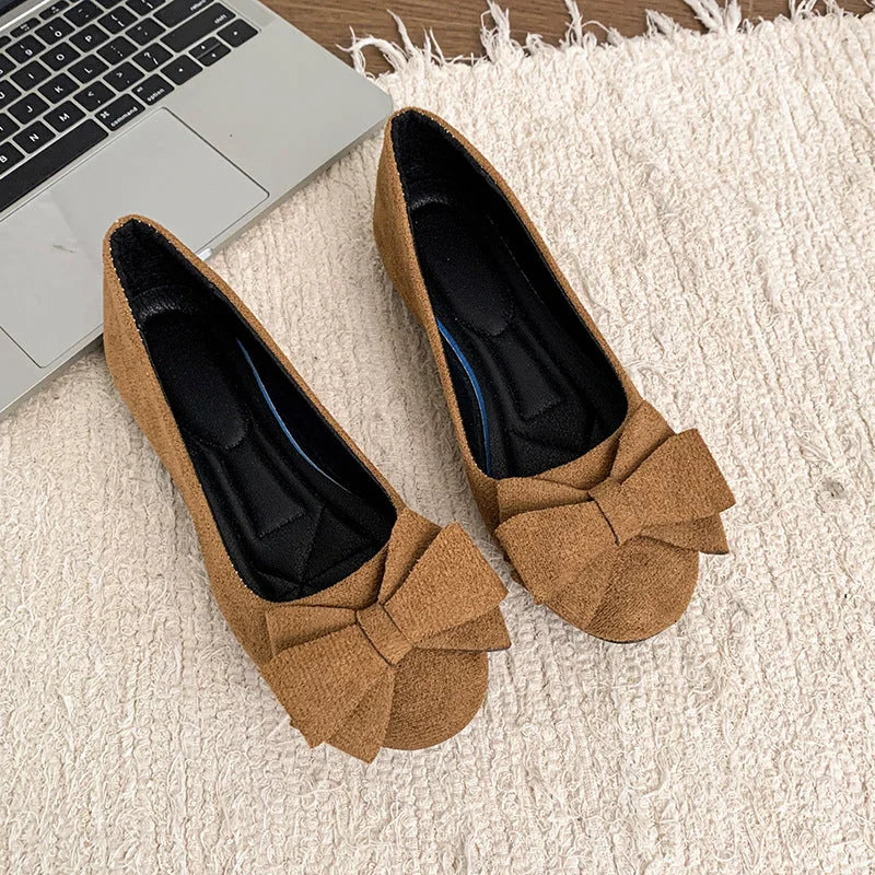 Pair of light brown bow ballet flats, top view