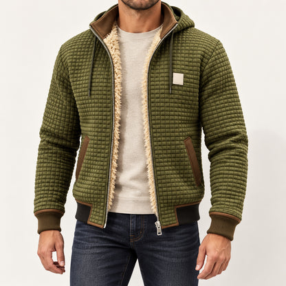 Front view of an olive green textured hooded jacket worn over a plain jumper.
