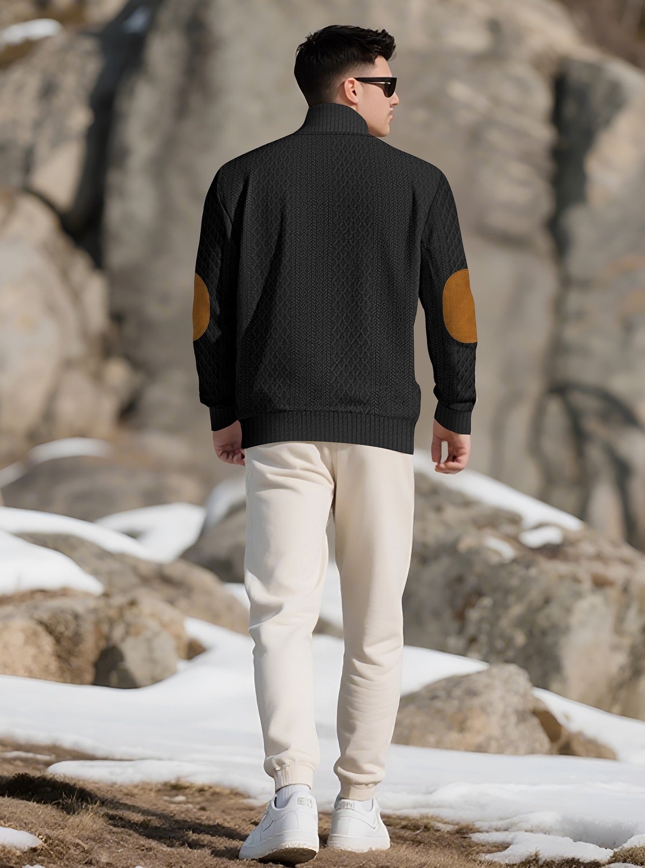 Model wearing the Black men's textured stand-collar pullover in a snowy mountain setting, back lifestyle view