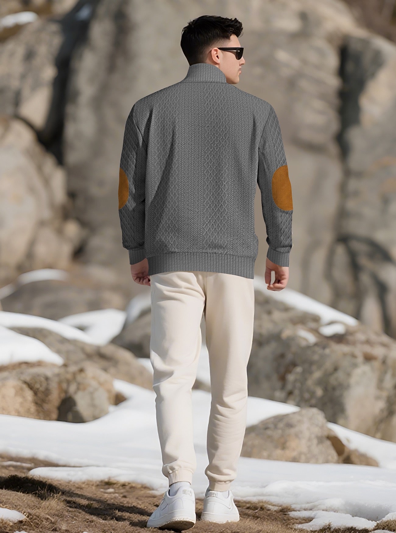Model wearing the Charcoal Grey men's textured stand-collar pullover in a snowy mountain setting, back lifestyle view