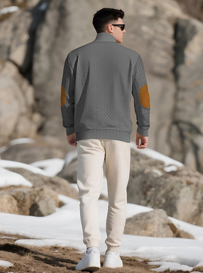 Model wearing the Charcoal Grey men's textured stand-collar pullover in a snowy mountain setting, back lifestyle view