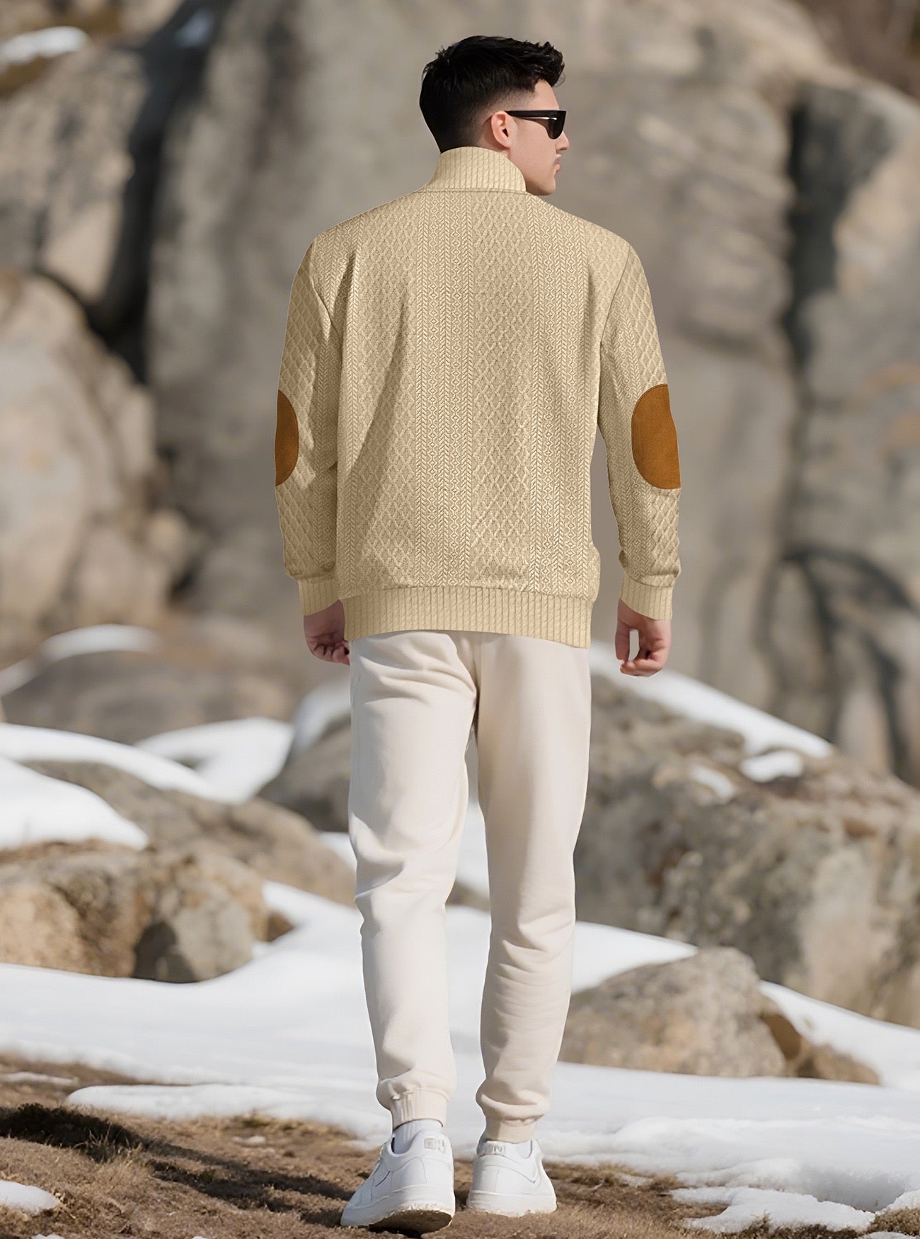 Model wearing the Oatmeal men's textured stand-collar pullover in a snowy mountain setting, back lifestyle view